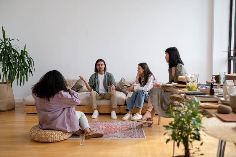 People socialising together in a comfortable living room — community living